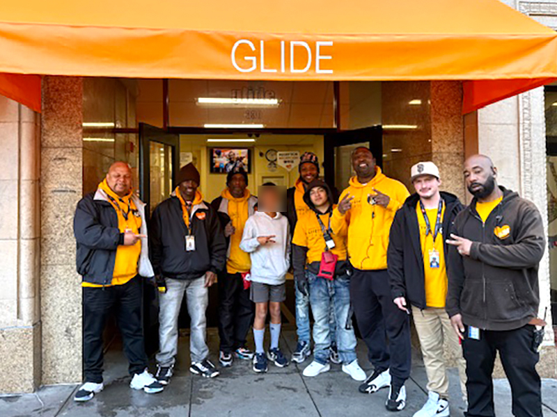 Youth volunteer delivering prepared lunches to staff at GLIDE Memorial Church